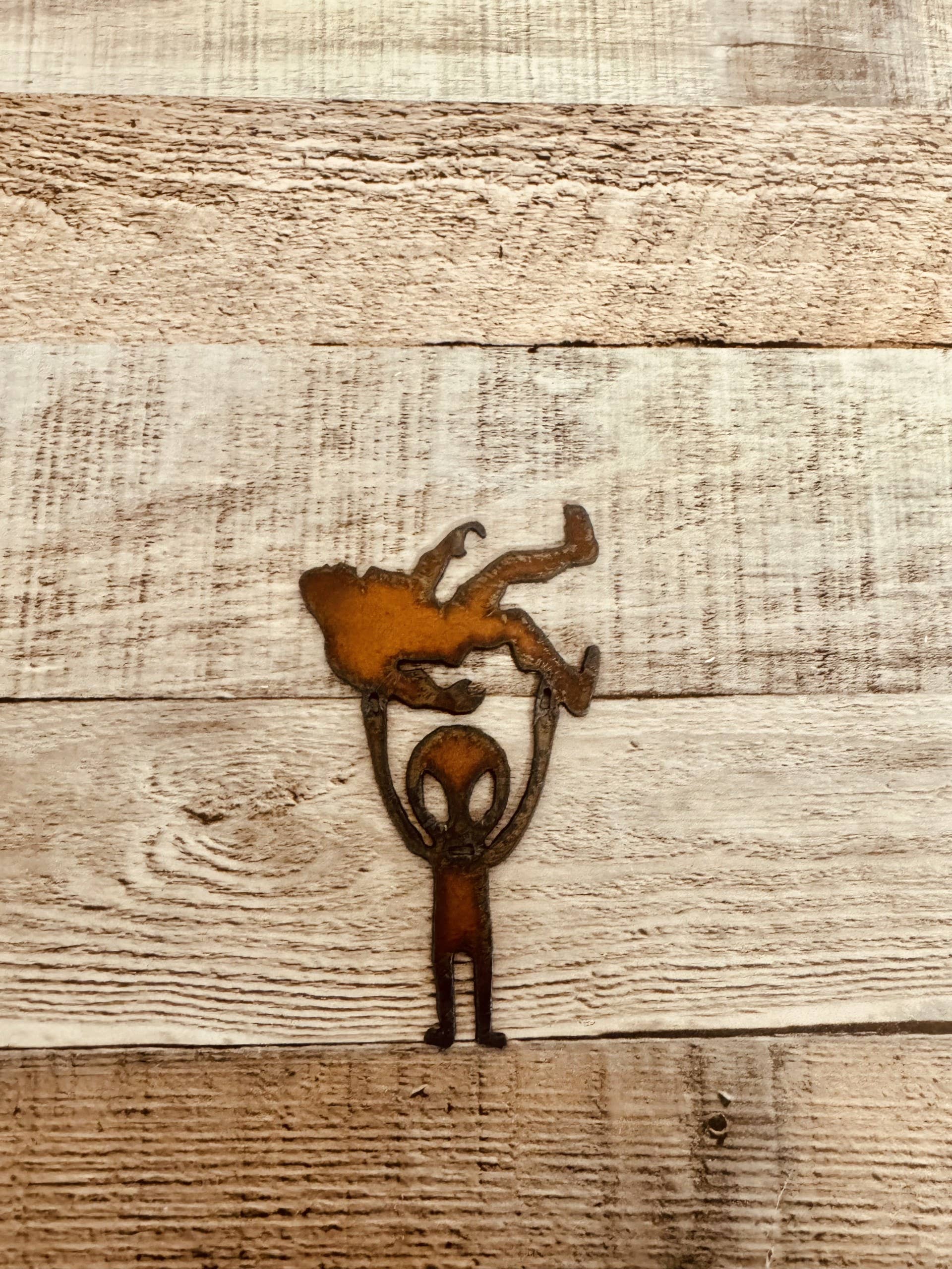 Alien Holding Bigfoot Rustic Metal Magnet Made in USA